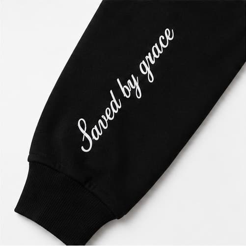 Saved by grace running down the sleeve in script, above the ribbed cuff